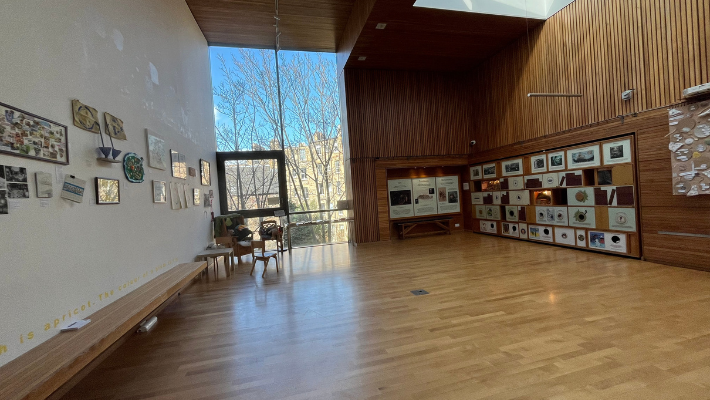The main hall at the Scottish Storytelling Centre. It is a big space with a bench running down the side. The floor is wooden.