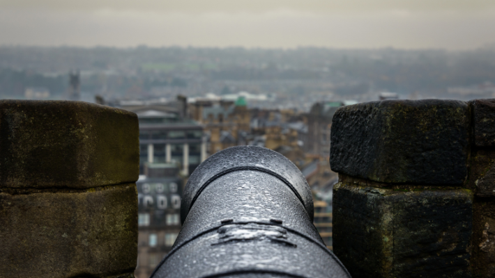 A view of the city from the castle from one of the castle's canons. The sky is grey. 