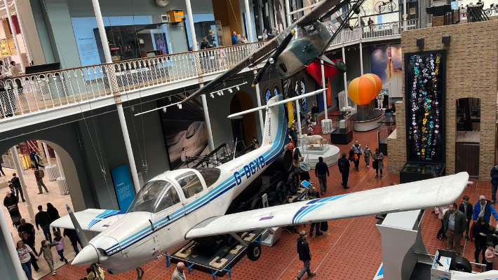 The Science Gallery at the National Museum of Scotland. There are two planes suspended from the ceiling.