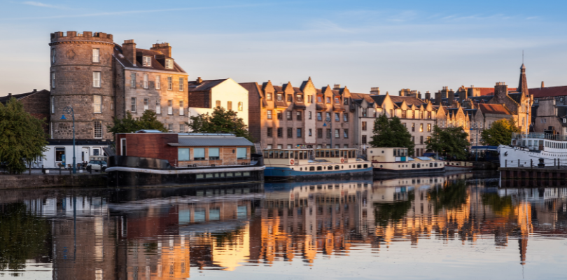 The Water of Leith reflects the buildings on the Shore in Edinburgh