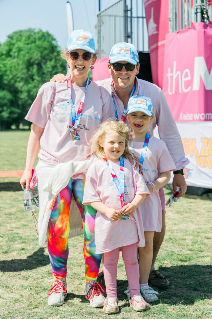 Family posing at the end of a 5k Zoom walk with medals